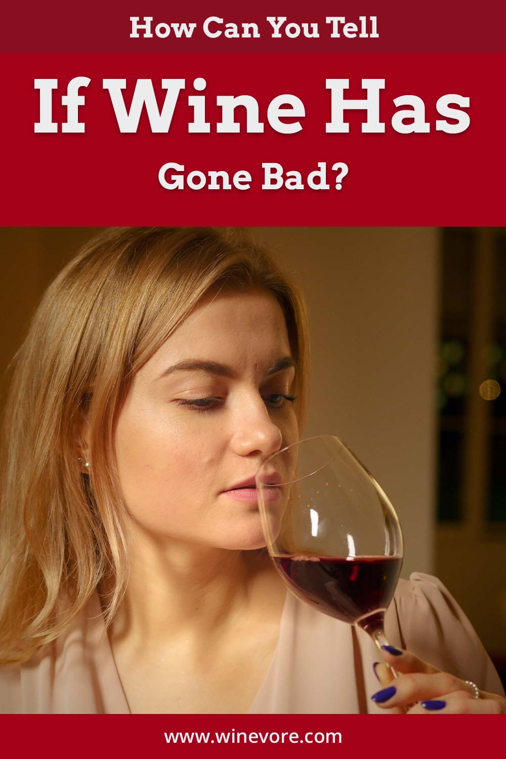 Woman testing a smell of red wine in a glass - How can you tell if it has gone bad?
