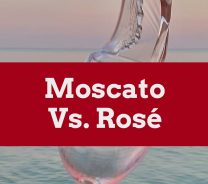 Rose wine in a wine glass in front of an ocean - Moscato vs. Riesling