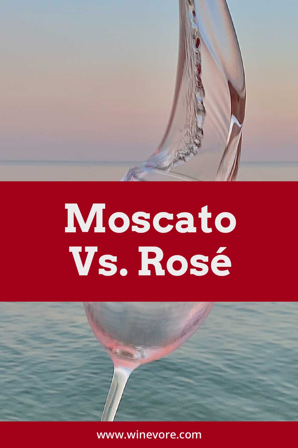 Rose wine in a wine glass in front of an ocean - Moscato vs. Riesling