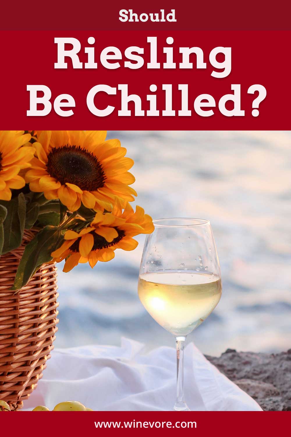 Wine glass on a white cloth near a basket with sunflowers in it - Should Riesling Be Chilled?