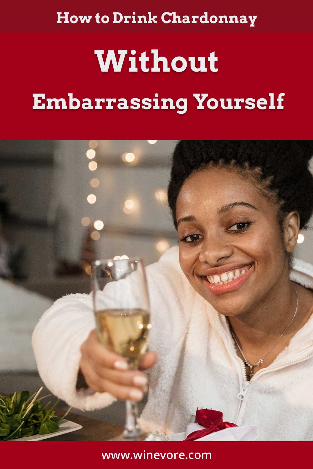 Woman smiling with a glass of wine in her hand - How to Drink Chardonnay Without Embarrassing Yourself?