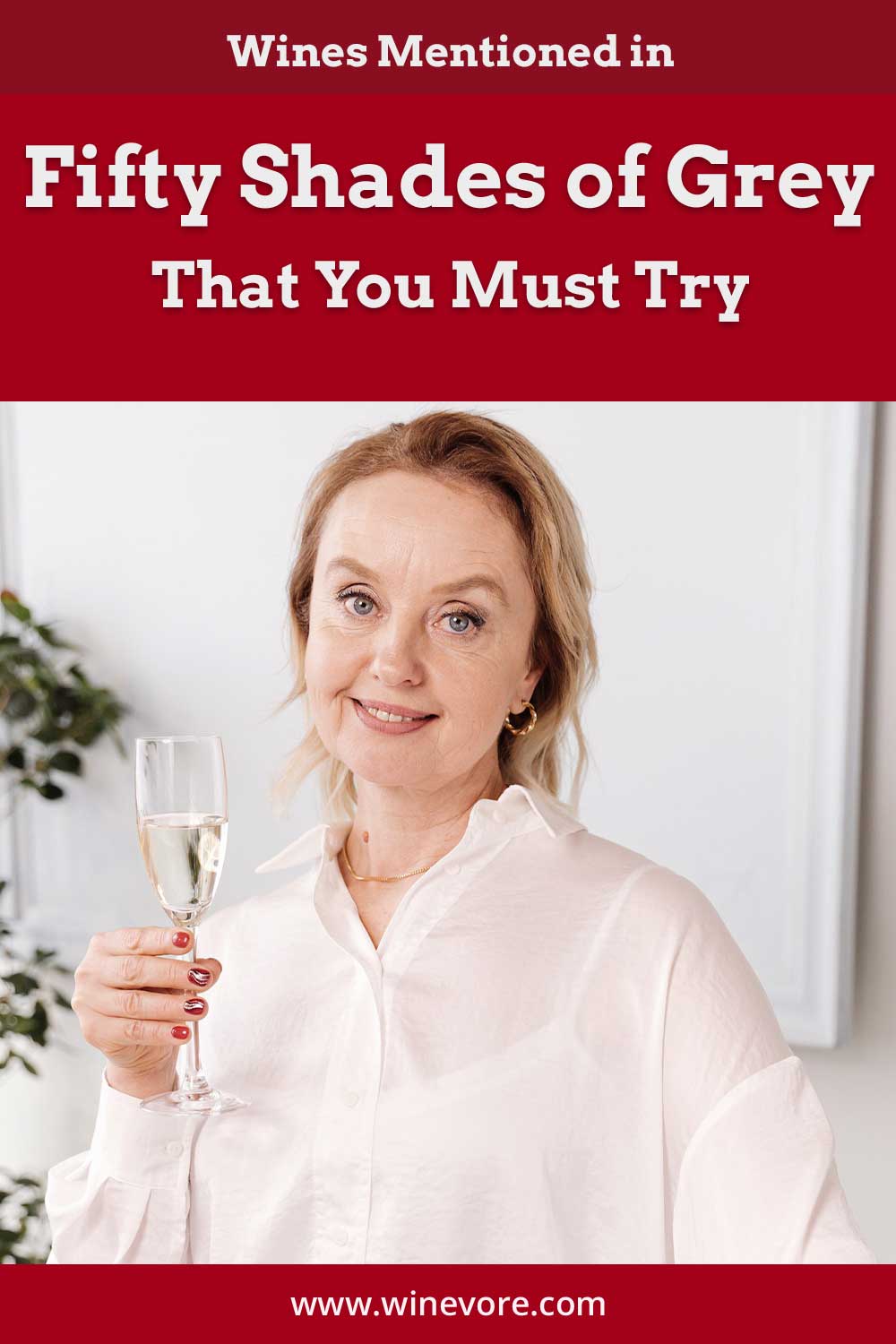 Woman in white shirt holding a wine glass - Wines Mentioned in Fifty Shades of Grey.
