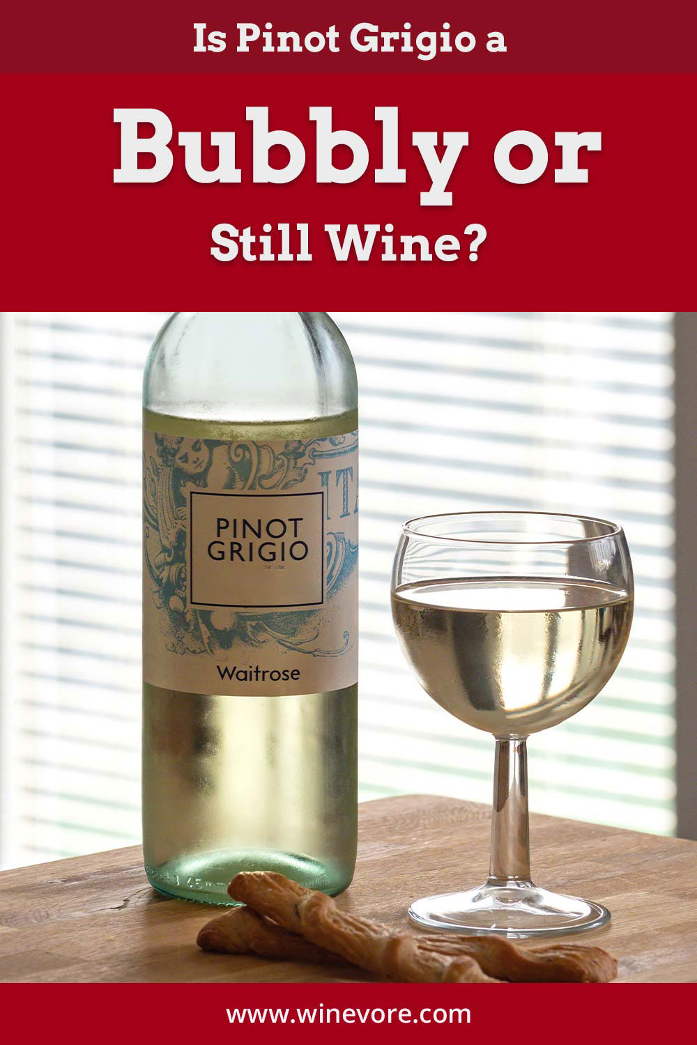 A bottle of Pinot Grigio and a glass on a wooden surface in front of a window - Is Pinot Grigio a Bubbly or Still Wine?