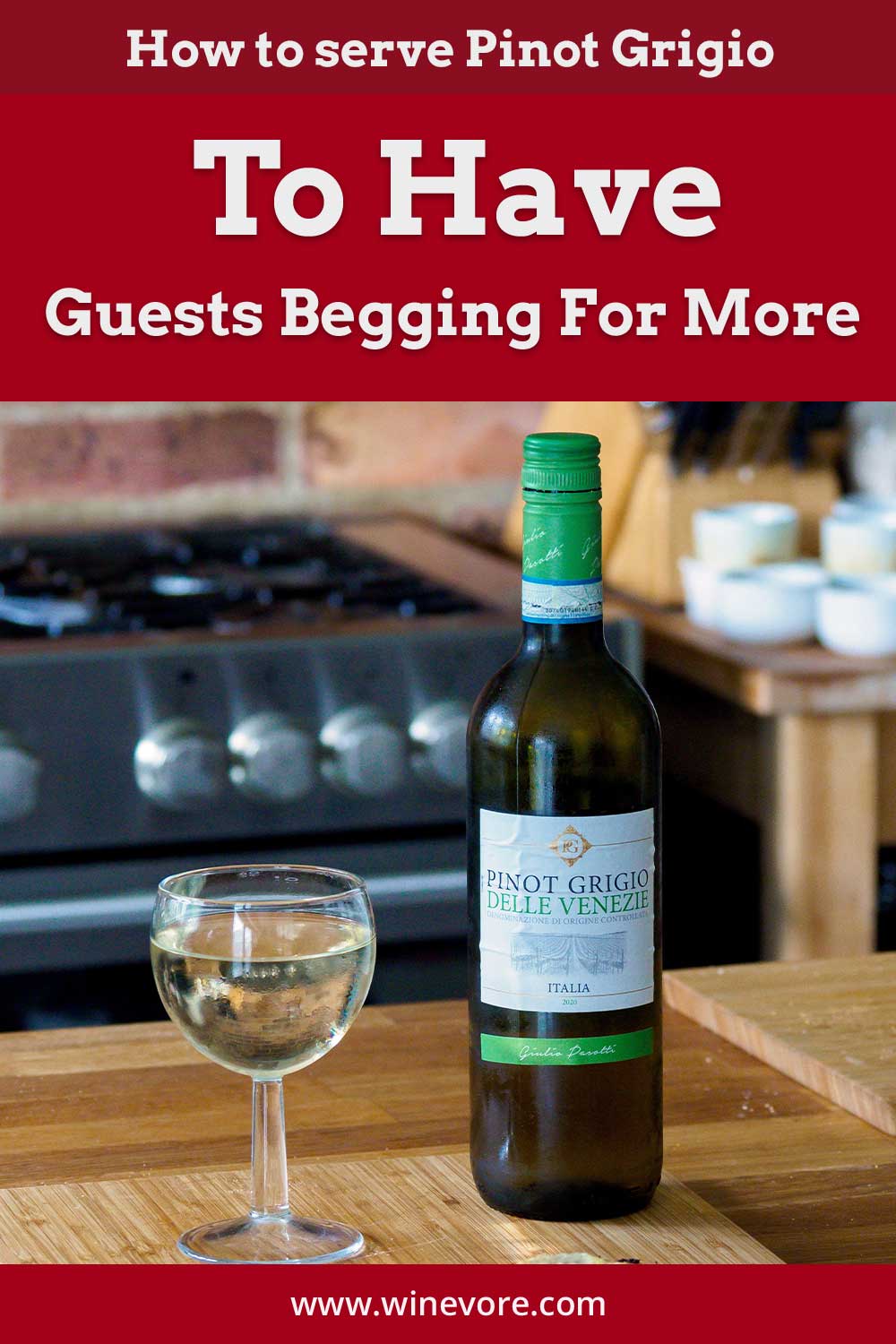 A glass of wine with a bottle on a wooden surface in front of a stove - How to serve Pinot Grigio.