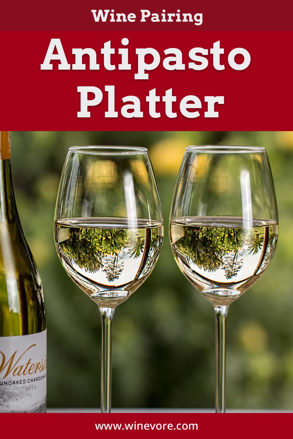 Two wine glasses with white wine in them near a wine bottle - Wine Pairing Antipasto Platter.