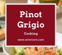Cooked prawn in a small white bowl with a wine glass behind it - Pinot Grigio Cooking.
